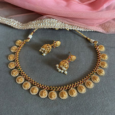 "Gold plated short necklace set with red and green kemp stones – traditional South Indian temple jewelry."