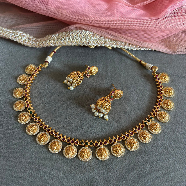 "Gold plated short necklace set with red and green kemp stones – traditional South Indian temple jewelry."