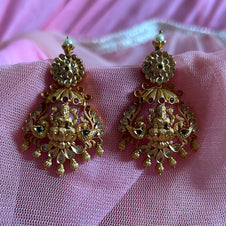 Gold earrings with intricate designs on a pink fabric background Gold necklace set with matching earrings on a gray surface IMITATION ARTIFICIAL ART FASHION JEWELLERY PINK STONES AD ANTIQUE PEACOCK DESIGN GOLD PLATED 